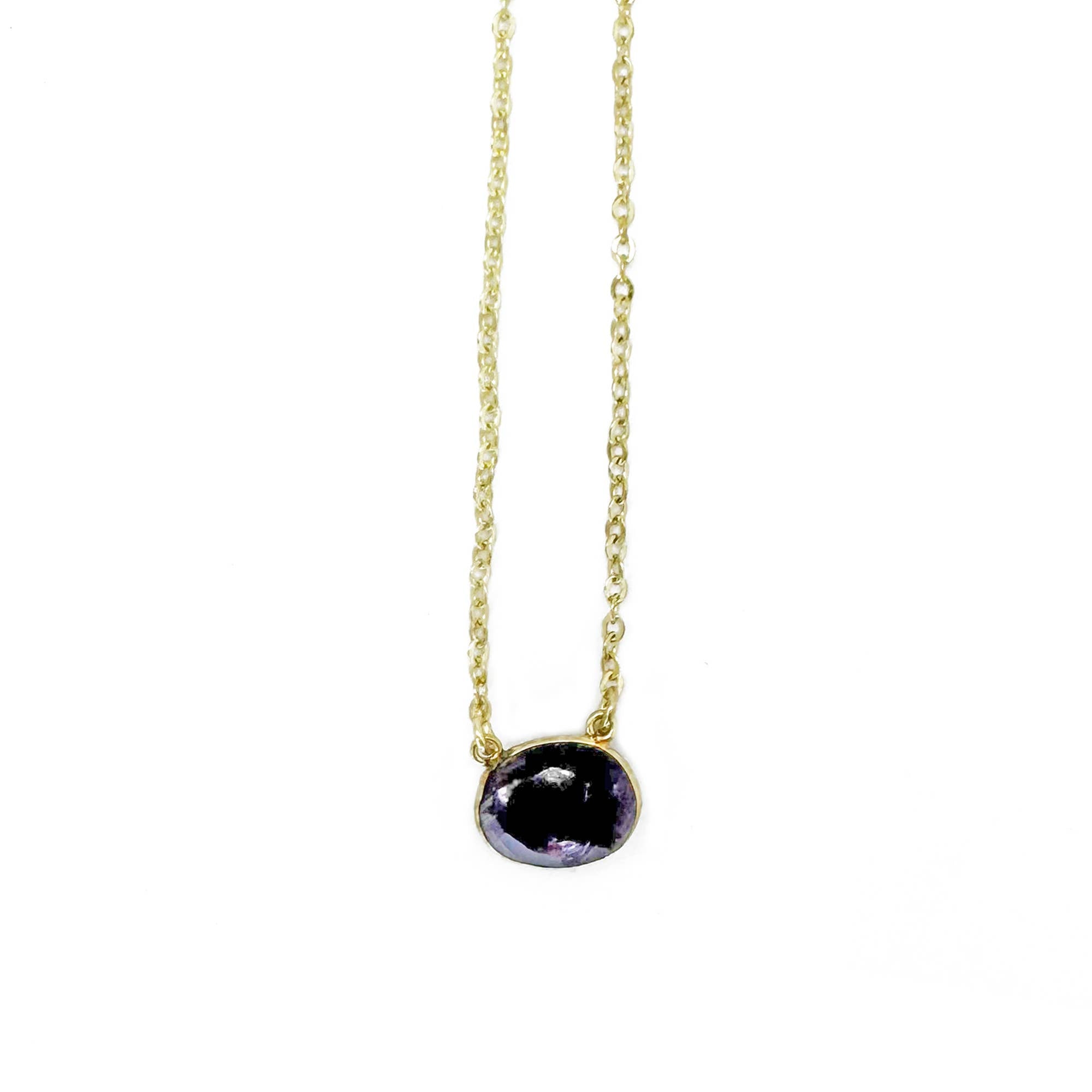 Necklace with a black gemstone pendant on a white background