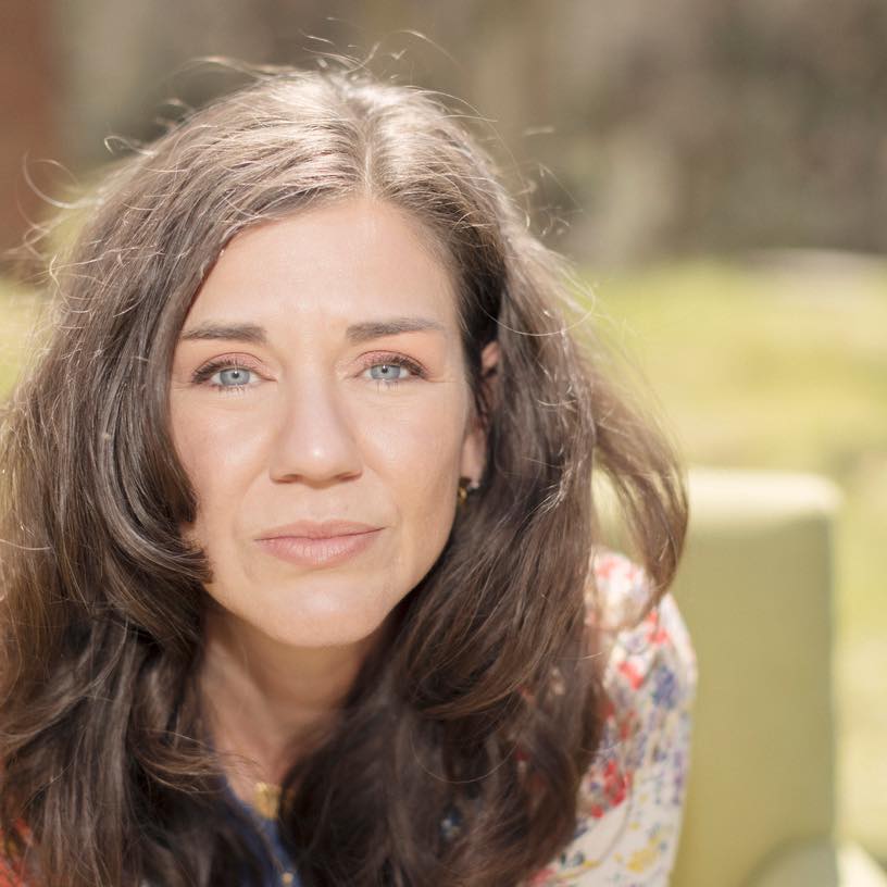 Barbara Bechtel, bohemian artist behind bmakesthings, wearing layered artisan jewelry in natural light.